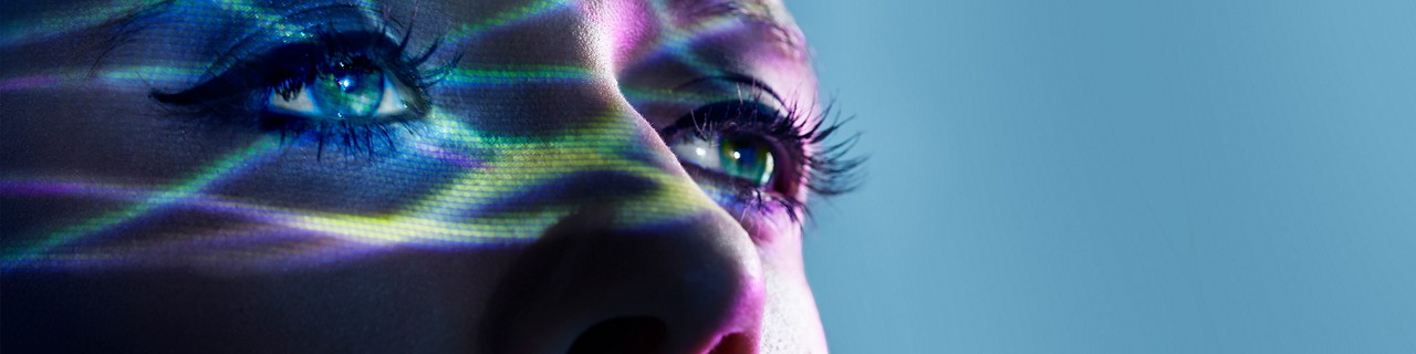 woman's eyes overlayed with colored light