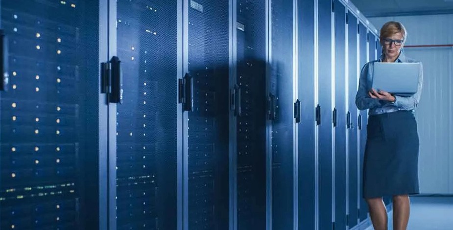 Woman on a laptop in a data center