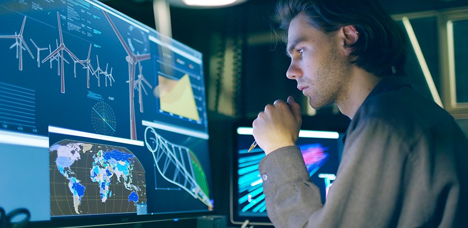 Man looking at data points on a large screen