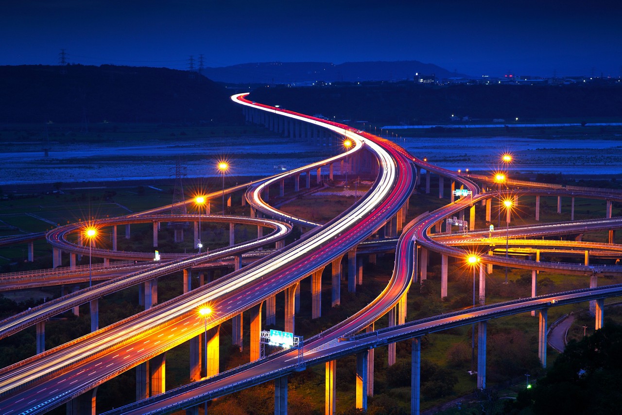 beams of light shining through freeway at night